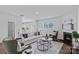 Inviting living room with a fireplace, hardwood floors, comfortable seating, and ample natural light at 128 Cherry Birch St, Mooresville, NC 28117