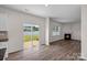 Sun-filled living room with hardwood floors, fireplace, and sliding glass doors to patio at 128 Cherry Birch St, Mooresville, NC 28117