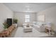 Comfortable living room with neutral tones, modern furniture and a bright window at 128 Cherry Birch St, Mooresville, NC 28117