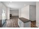 Open layout showcases a kitchen island leading to a living area with a fireplace at 128 Cherry Birch St, Mooresville, NC 28117