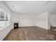 Spacious living room with hardwood floors, a window, and a classic fireplace at 128 Cherry Birch St, Mooresville, NC 28117