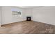 Bright living room featuring beautiful wood floors and a cozy fireplace at 128 Cherry Birch St, Mooresville, NC 28117