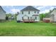 Spacious backyard with a wooden deck, green grass, and partial fencing at 1308 Stonewyck Dr, Salisbury, NC 28146