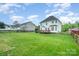 Expansive backyard with lush green lawn, wooden deck, and partial fencing at 1308 Stonewyck Dr, Salisbury, NC 28146