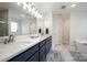Bright bathroom featuring double sink vanity, marble floors, soaking tub and glass enclosed shower at 1308 Stonewyck Dr, Salisbury, NC 28146