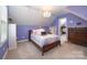 Bedroom with sloped ceiling, queen bed, purple walls and walk-in closet at 1308 Stonewyck Dr, Salisbury, NC 28146