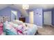 Cozy bedroom featuring soft lavender walls, plush pillows, and a comfortable queen bed at 1308 Stonewyck Dr, Salisbury, NC 28146
