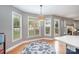 Sunlit breakfast nook with a decorative rug, three windows, and a stylish pendant light at 1308 Stonewyck Dr, Salisbury, NC 28146