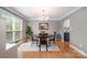 Bright dining area featuring a modern chandelier, large windows and light grey walls at 1308 Stonewyck Dr, Salisbury, NC 28146