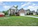 Charming two-story brick home with an attached two-car garage and well-maintained lawn at 1308 Stonewyck Dr, Salisbury, NC 28146