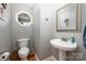 Neat half-bathroom with a unique octagonal window, pedestal sink and bronze fixtures at 1308 Stonewyck Dr, Salisbury, NC 28146