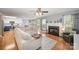 Open living room with hardwood floors, a fireplace, and seamless access to the kitchen, ideal for entertaining at 1308 Stonewyck Dr, Salisbury, NC 28146