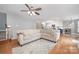 Spacious living area featuring hardwood floors, neutral walls, and seamless flow to the kitchen and stairs at 1308 Stonewyck Dr, Salisbury, NC 28146