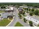 Aerial view of a charming town showcasing the downtown area, businesses, and tree-lined streets at 146 Kerri Dawn Ln, Locust, NC 28097