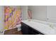Bathroom features a black vanity with marble countertop and a shower with a colorful shower curtain at 146 Kerri Dawn Ln, Locust, NC 28097