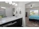 Well-lit bathroom with a vanity featuring countertop space, with the main bedroom in the background at 146 Kerri Dawn Ln, Locust, NC 28097
