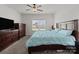Bedroom with a queen-sized bed and light blue comforter, with an adjacent window and dresser at 146 Kerri Dawn Ln, Locust, NC 28097
