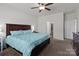 Bedroom featuring a queen-size bed with nightstands, ceiling fan and windows for natural light at 146 Kerri Dawn Ln, Locust, NC 28097