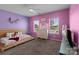 Bright bedroom featuring with two windows, carpet flooring, and closet for ample storage at 146 Kerri Dawn Ln, Locust, NC 28097