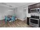 Cozy dining area with a modern table, stylish chairs, and stainless steel appliances at 146 Kerri Dawn Ln, Locust, NC 28097