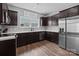 Modern kitchen with stainless steel appliances, dark cabinetry, and bright countertops at 146 Kerri Dawn Ln, Locust, NC 28097