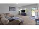 Comfortable living room with a large sectional couch, media console, and ample natural light at 146 Kerri Dawn Ln, Locust, NC 28097