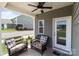 Covered patio features outdoor seating and a ceiling fan at 146 Kerri Dawn Ln, Locust, NC 28097