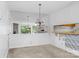 Dining room with mirrored wall, decorative light fixture, and view of living room at 1604 Sharon W Rd, Charlotte, NC 28210