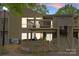 Two-story home with a deck and stairs to the main entrance at 1604 Sharon W Rd, Charlotte, NC 28210