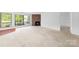 Open-concept living room with large windows and a brick fireplace feature at 1604 Sharon W Rd, Charlotte, NC 28210