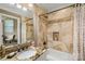 Beautiful bathroom featuring a granite vanity, oval sink, bathtub with marble tiling and a shower niche at 168 Blue Ridge Trl, Mooresville, NC 28117