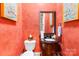 Charming half-bathroom with wallpaper, mirror, and vanity at 168 Blue Ridge Trl, Mooresville, NC 28117