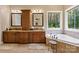 This bathroom features dual sinks, a soaking tub, and a window with a private view at 168 Blue Ridge Trl, Mooresville, NC 28117