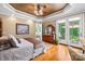 This bedroom features hardwood floors, a ceiling fan, and private access to a deck and bathroom at 168 Blue Ridge Trl, Mooresville, NC 28117
