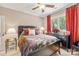 Comfortable bedroom with a decorative headboard, ceiling fan, and a large window at 168 Blue Ridge Trl, Mooresville, NC 28117