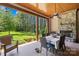 Covered patio with stone fireplace, ceiling fan, and dining table, ideal for outdoor entertaining at 168 Blue Ridge Trl, Mooresville, NC 28117