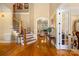 Inviting foyer with hardwood floors, staircase, and arched doorway leading to a cozy living area at 168 Blue Ridge Trl, Mooresville, NC 28117