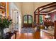 Elegant foyer with hardwood floors, a grand arched doorway, and sophisticated decor at 168 Blue Ridge Trl, Mooresville, NC 28117