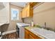 Laundry room with washer, dryer, utility sink, and wooden cabinets for storage at 168 Blue Ridge Trl, Mooresville, NC 28117