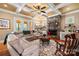 Cozy living room with stone fireplace, coffered ceiling, and plush sectional sofa at 168 Blue Ridge Trl, Mooresville, NC 28117