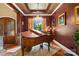 Sophisticated living room featuring a grand piano, elegant chandelier, and custom ceiling at 168 Blue Ridge Trl, Mooresville, NC 28117