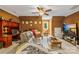 Cozy living room offers warm paint, a ceiling fan, plush seating, and a desk area at 168 Blue Ridge Trl, Mooresville, NC 28117