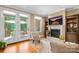 This living room features a fireplace, hardwood floors, and glass doors leading to a deck at 168 Blue Ridge Trl, Mooresville, NC 28117