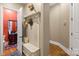 Mud room with a built-in bench with storage, coat hooks, and nearby half-bathroom at 168 Blue Ridge Trl, Mooresville, NC 28117
