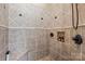 This shower features neutral tile, a built-in bench, and a built-in shower niche at 168 Blue Ridge Trl, Mooresville, NC 28117