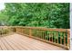 Exterior shot of a wood deck with wood railing and view of the natural landscape at 17513 Hawks View Dr, Fort Mill, SC 29707