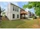 Backyard view showcasing a well-maintained lawn, patio, and upper-level deck, perfect for outdoor living at 17513 Hawks View Dr, Fort Mill, SC 29707
