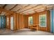 Unfinished basement space with framed walls, windows, and a door, providing natural light and customization options at 17513 Hawks View Dr, Fort Mill, SC 29707