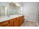 This bathroom offers a double sink vanity, neutral tile, and glass enclosed shower at 17513 Hawks View Dr, Fort Mill, SC 29707