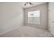 A bright, neutral bedroom features a ceiling fan and a window allowing lots of natural light at 17513 Hawks View Dr, Fort Mill, SC 29707